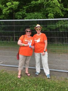 Two adults in orange Band on the Run T-shirts smile for the camera.