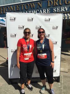 Two people pose for a photo with their finisher medals after the race.