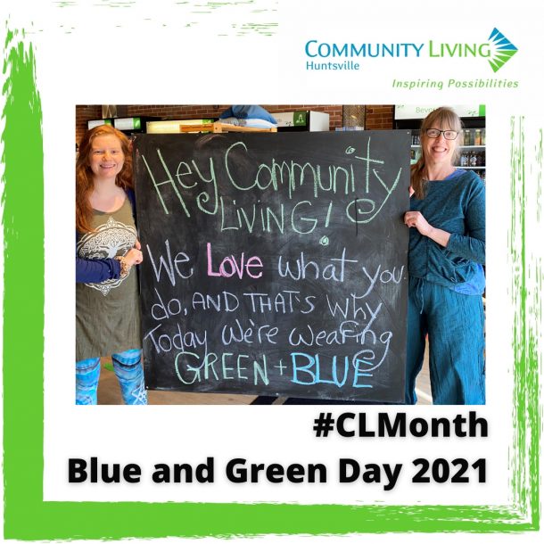 Two women in blue and green hold a sign that reads: Hey Community Living we love what you do and that's why today we're wearing Green and Blue