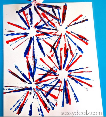 Image shows a white piece of paper with blue and red paint in the shape of four fireworks.