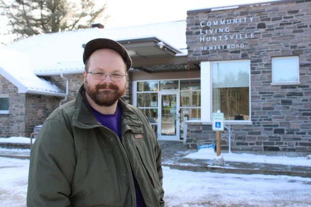 A photo of Christopher Jordan-Stevens. He is standing outside Community Living Huntsville's offices.