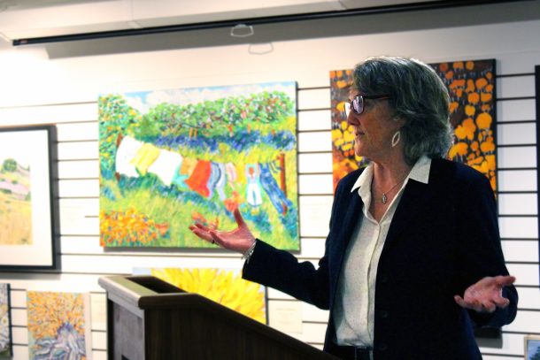 A woman talking at a podium.