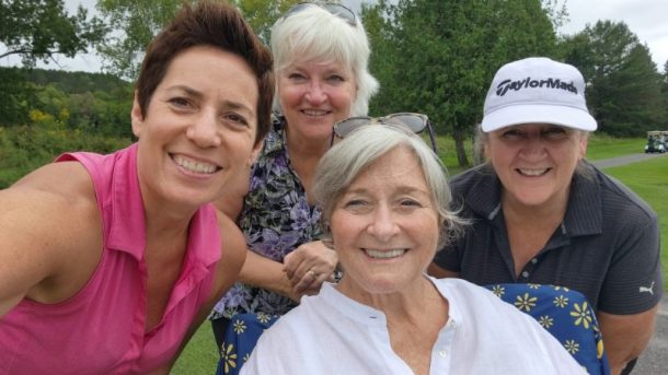 4 women snap a selfie on a golf course