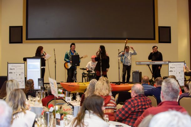 a rock band of 5 people and the MC, Jennifer, on stage
