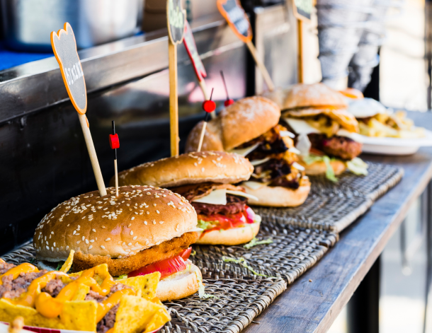 smash burgers on food truck ledge.