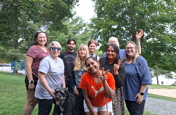 A group of people in a park pose for a photo together